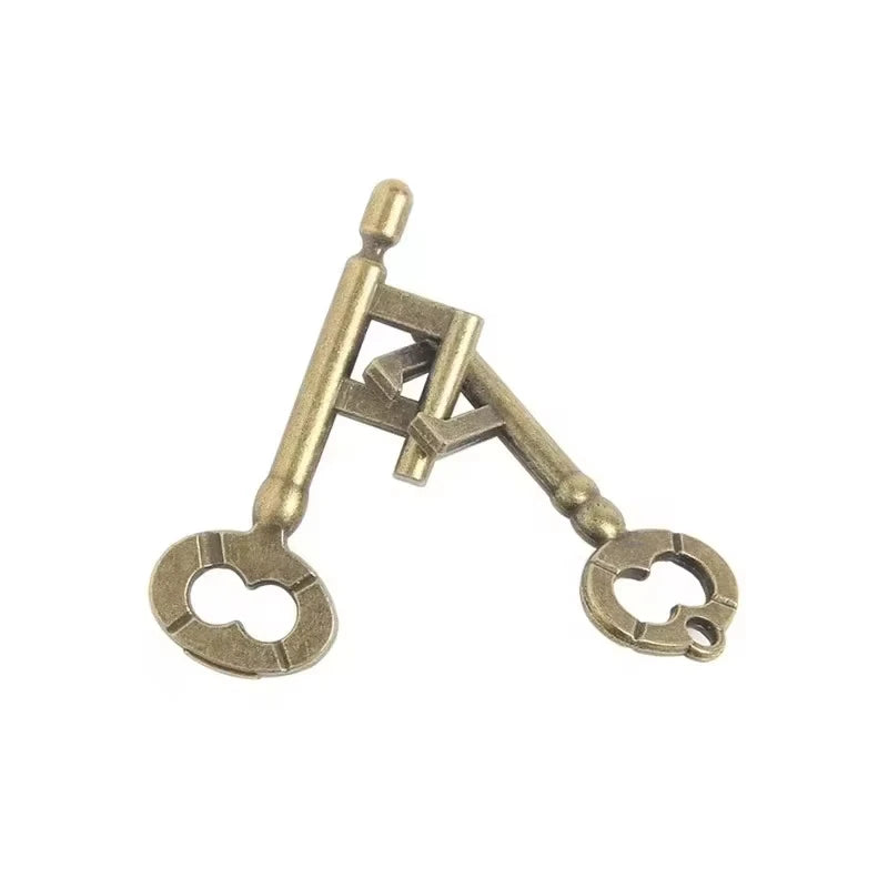 Pair of bronze interlocking key puzzle variant on a white background