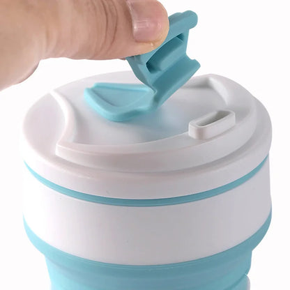 Collapsible blue and white cup with a hand lifting the lid.