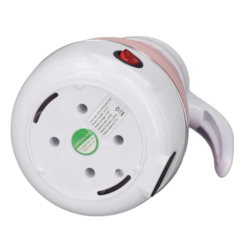 bottom view of pink foldable electric kettle with a red power switch on a white background