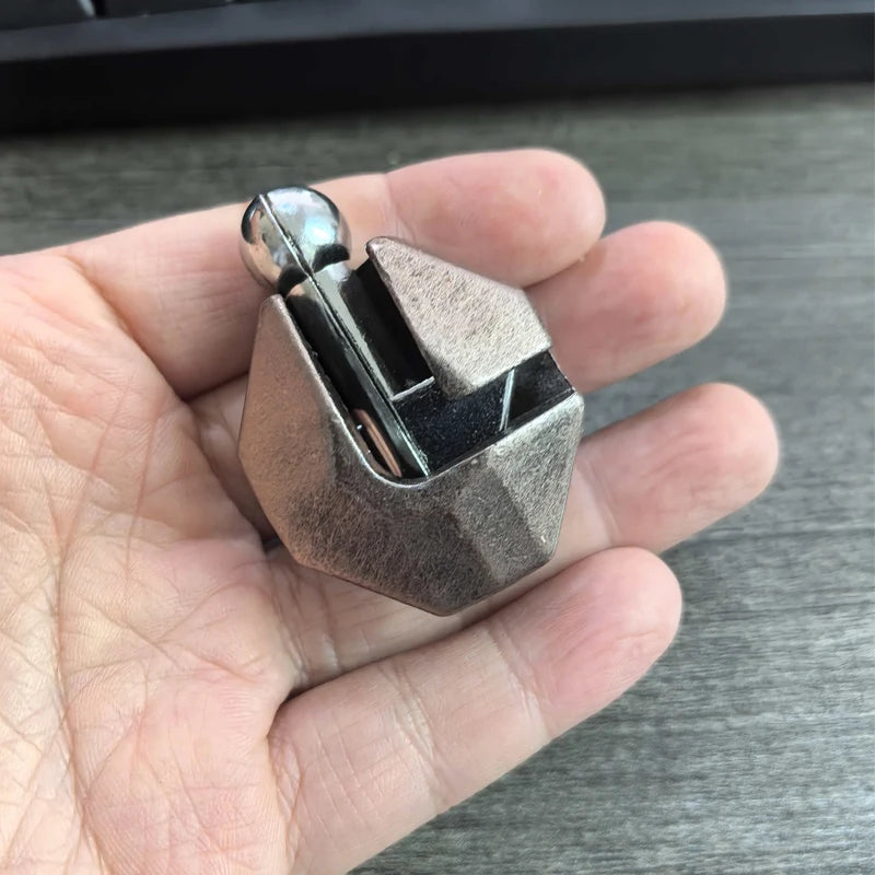 The geometric metal lock puzzle held in a hand against a neutral background