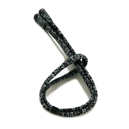 Black and White mix colored acrylic strap tied in a loose knot on a white background