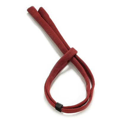 Red colored acrylic strap tied in a loose knot on a white background