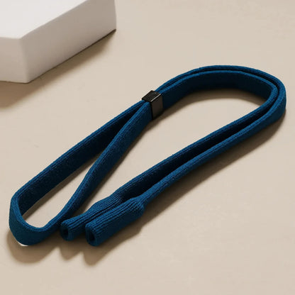 Blue neck strap with a black clip for adjustments on a beige surface