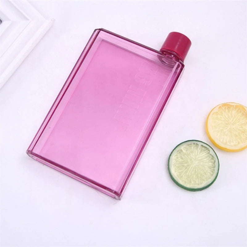 Pink water bottle with a red cap on a white background