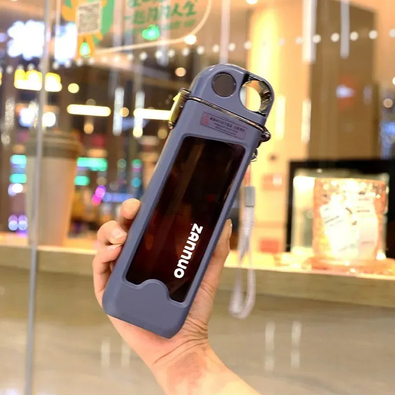 Hand holding a blue square water bottle in front of a store window.