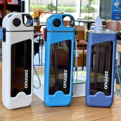 Three square sports bottles on a wooden surface with a blurred indoor background.