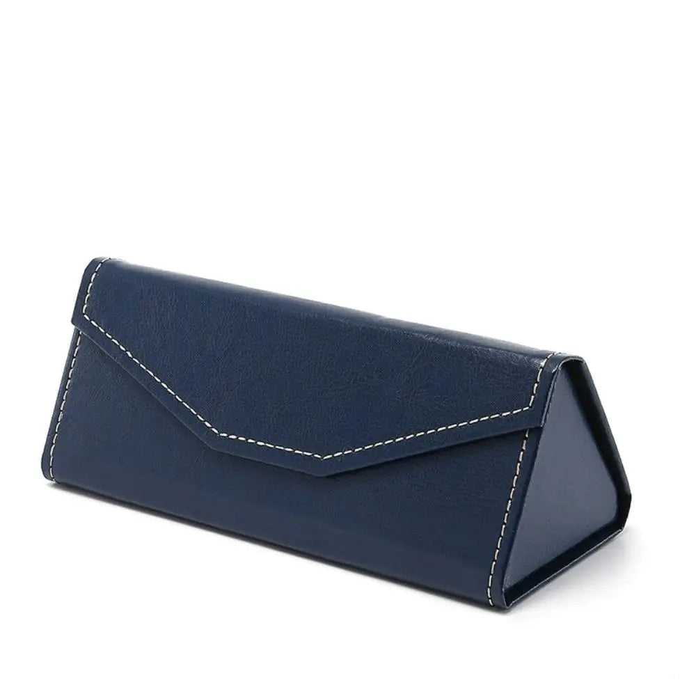 Navy blue triangular faux leather eyewear case with white stitching on a white background