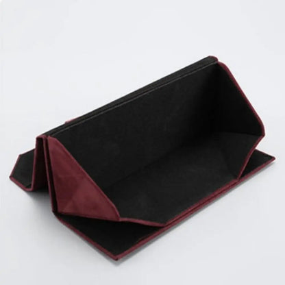 An interior shot of a red triangular case showcasing the black plush fabric interior.