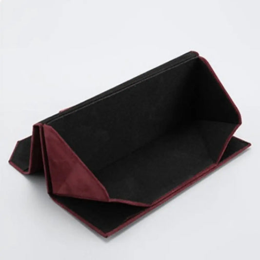 An interior shot of a red triangular case showcasing the black plush fabric interior.
