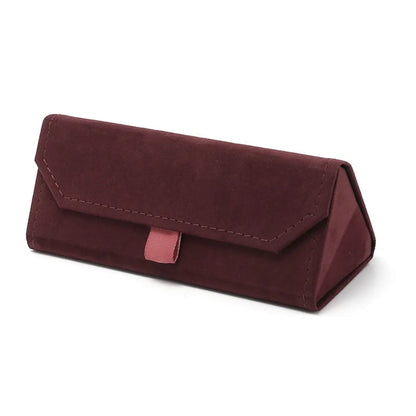 Wine red triangular velvet eyewear case on a white background.