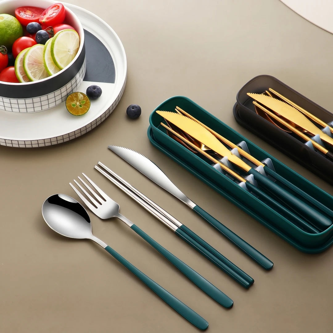 Set of silver cutlery with teal handles on a beige surface, next to a container of gold cutlery.