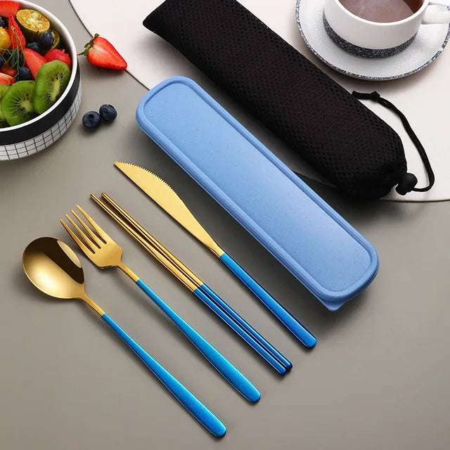 Set of gold and blue cutlery with a blue case on a gray surface.