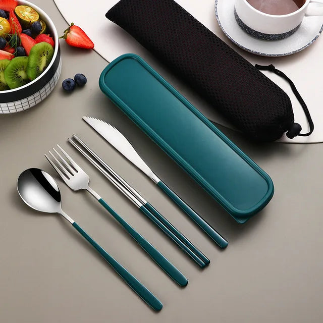 Teal travel cutlery set with case on a table with fruit and tea.