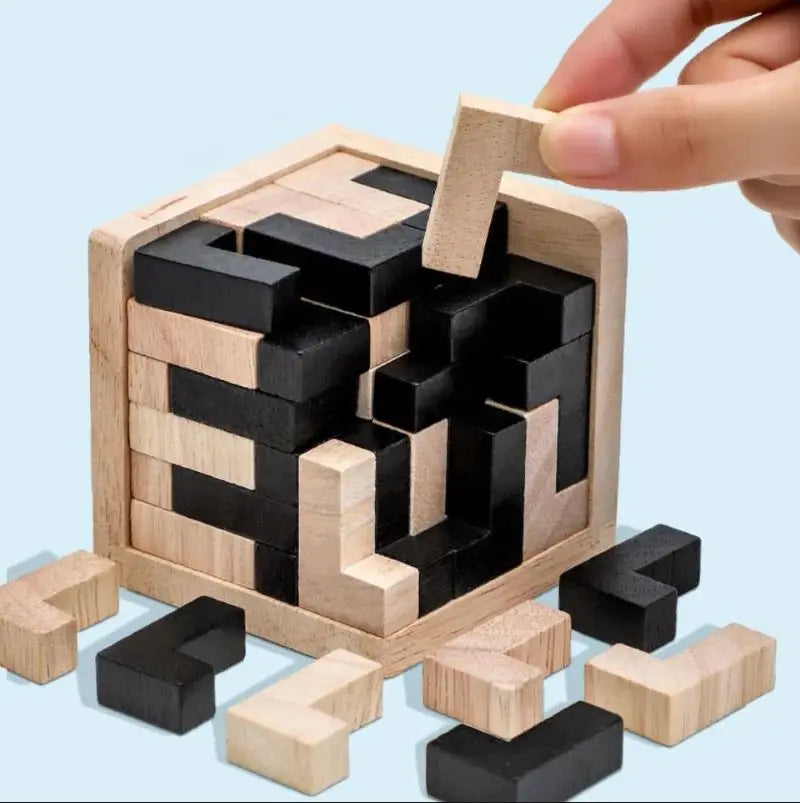 Wooden 3d cube puzzle with black and natural L-shaped wood blocks on a light blue background