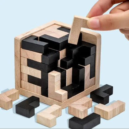 Wooden 3d cube puzzle with black and natural L-shaped wood blocks on a light blue background