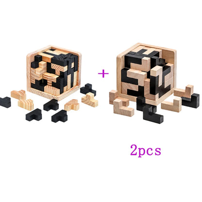 Two variations of the wooden 3d cube puzzle, one with L shaped pieces and the other with T shaped pieces, scattered on a white surface