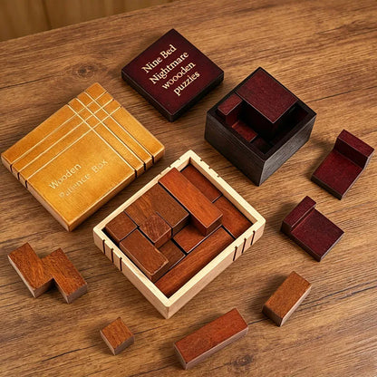 Both variants of the wooden packing puzzle box arranged on a rustic wooden tabletop. The pieces and boxes show different wood tones, including light natural wood, medium reddish-brown wood, and dark burgundy wood.