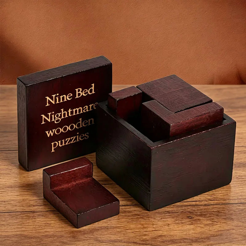 The Nine Bed variant shown with its box and several dark reddish-brown wooden puzzle pieces on a wooden tabletop against a brown backdrop.