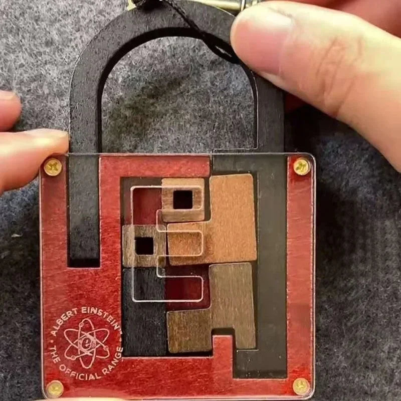 Red and black wooden padlock puzzle, held by a hand on a gray background