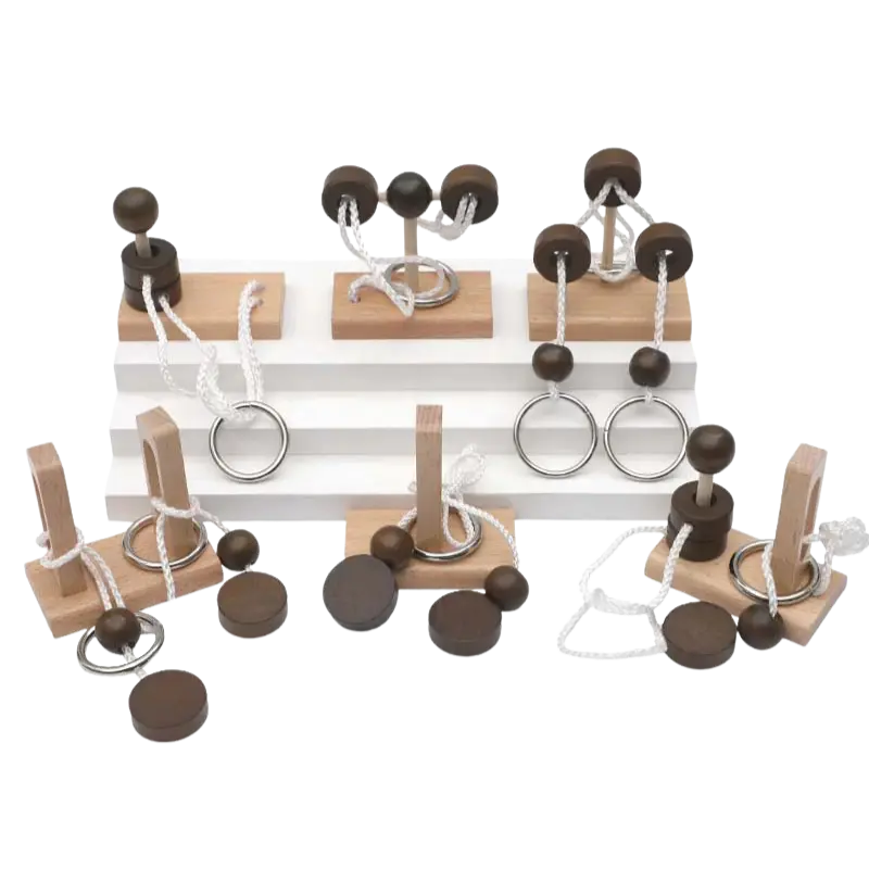 Assortment of different wooden rope untie puzzles laid out on a transparent background.
