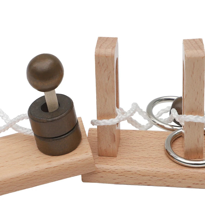 Close-up shot of the components that make up the wooden rope untie puzzles including wood base, rope and metal rings.