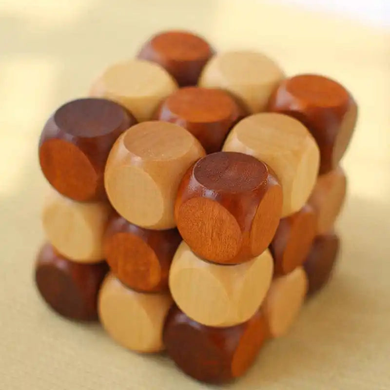 Wooden twist cube puzzle with rounded pieces making up the cube shape on a beige background